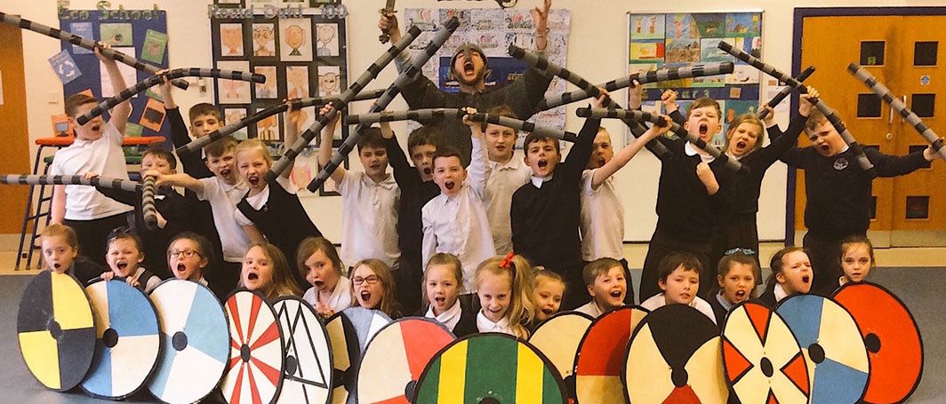 School children wielding Viking shields as part of experience day