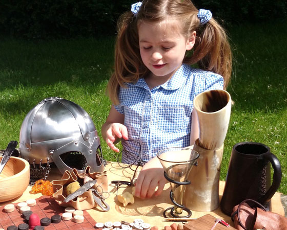 Children playing with Viking tools
